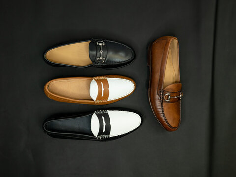 Penny and bit loafers on a dark black background. Fashion footwear.
