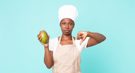black african american adult chef woman hwith a mango