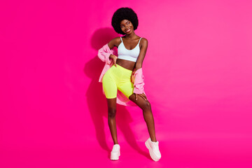 Fototapeta na wymiar Photo of sweet charming dark skin lady wear casual shirt looking empty space smiling isolated pink color background