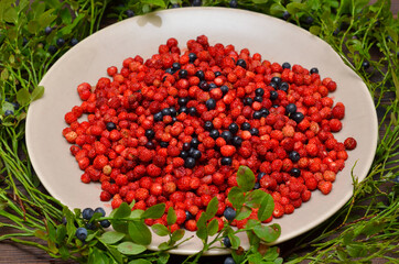 wild berries strawberries and blueberries on a plate