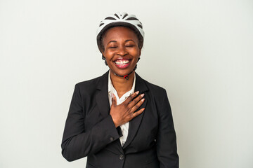 Young business african american woman wearing a bike helmet isolated on white background laughs out loudly keeping hand on chest.