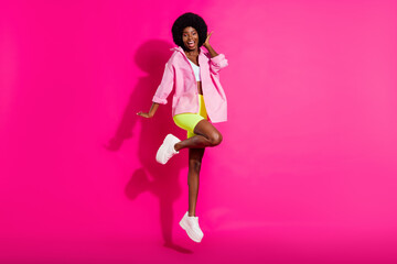 Full body photo of young black girl happy positive smile have fun jump up isolated over pink color background