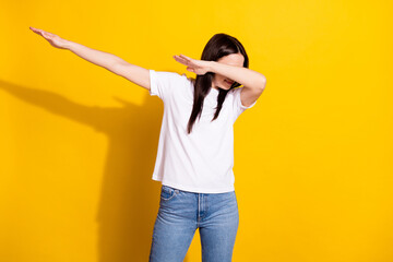 Photo of sweet funny young woman wear white t-shirt dancing showing dab sign isolated yellow color background