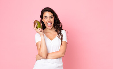 pretty young woman holding a mango fruit