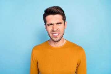 Fototapeta premium Photo of angry brunet millennial guy wear brown shirt isolated on blue color background