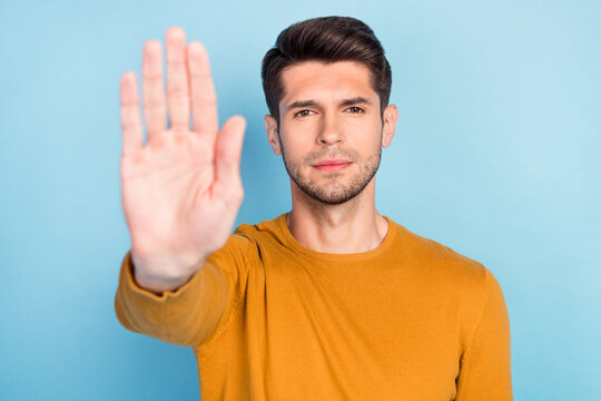 Photo Of Young Man Show Hand No Stop Sign Enough Ban Block Prohibition Isolated Over Blue Color Background