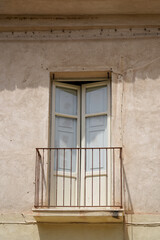 balcony with open shutter doors in vintage wall
