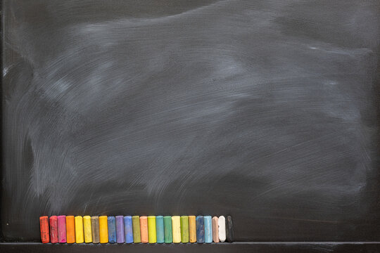 Blackboard with colored chalks