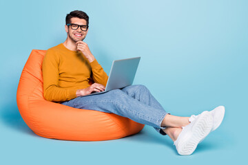 Full body profile side photo of young man happy positive smile programmer use laptop isolated over blue color background