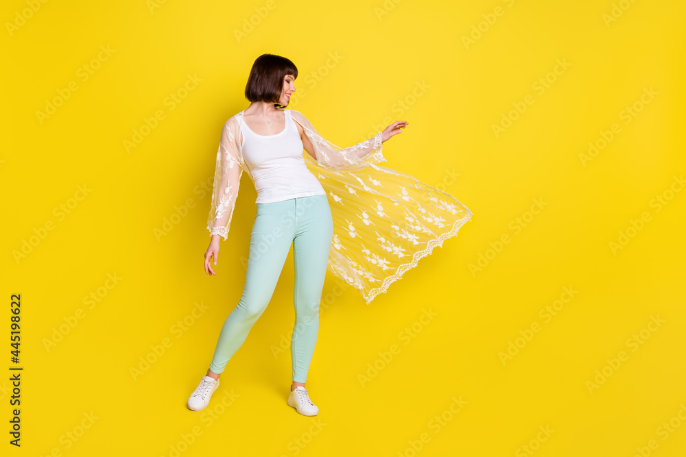 Sticker Full length photo of charming happy nice young woman shawl fly wind summer isolated on yellow color background