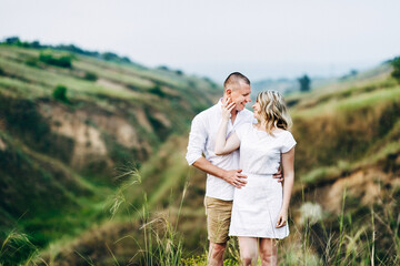 a guy with a girl in light clothes on the background of a green canyon