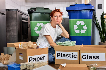 Woman throws paper trash in the trash sorting waste