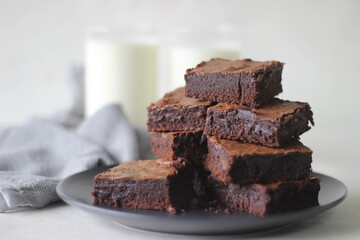 Home baked fudgy chocolate brownie sliced in square blocks and stacked one over the other