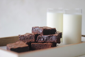 Home baked fudgy chocolate brownie sliced in square blocks and stacked one over the other