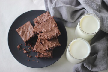 Home baked fudgy chocolate brownie sliced in square blocks and stacked one over the other