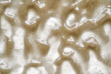 Light gray texture of cosmetic product, body scrub isolated on white background