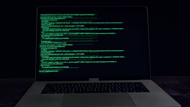Code On A Laptop Computer Monitor In A Dark Room
