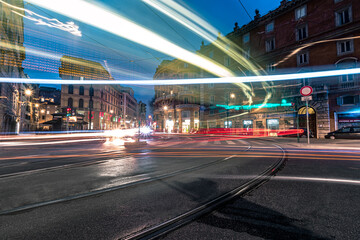 Obraz na płótnie Canvas traffic at night. neon lights in the streets of Rome, Italy. Long exposure photography 