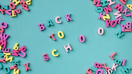 Stop motion. The text BACK TO SCHOOL emerges from the chaotic movement of multicolored letters.