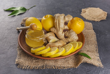 honey, lemon and ginger on wooden background healthy lifestyle