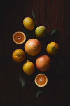 different citrus fruit orange lemon grapefruit on dark background with soft light