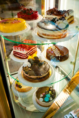 cakes and pastries on display in a bakery