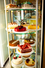 cakes and pastries on display in a bakery