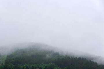 Fog covering mountain lines in Basque country, Spain. Concepts for loneliness, depression, mystery