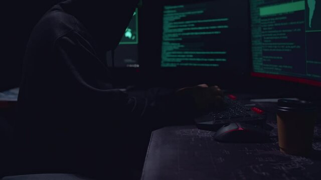  Man Hancker Hands Typing Data On A Keyboard, Seen On A Computer Monitor
