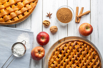 Homemade Apple Pies on a white wooden background, top view. The classic fall Thanksgiving dessert - organic apple pie. (Turkish name; elmali turta)