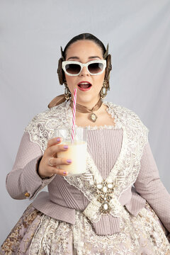 young girl dressed as fallera caught drinking horchata