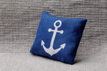 Blue pillow with white anchor © heliopix