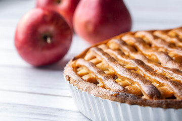 Homemade apple pie with red and green apples around