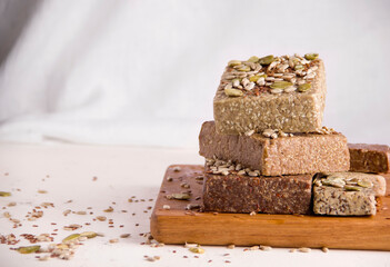 Halva on a wooden board. White background. Copy space