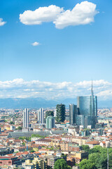 Vertical aerial view of Milan skyline, Italy, with business skyscrapers. In the distance the alps...