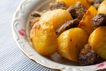 From traditional delicious Turkish food; potato and meat dish in casserole (Turkish name; Guvec tas kebabi, tandir)