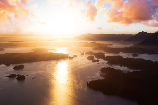 Aerial Canadian Landscape at the West Pacific Ocean Coast. Bright colorful vibrant sunset Art Render. Taken from Airplane in Tofino, Vancouver Island, British Columbia, Canada.