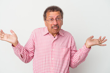 Middle aged indian man isolated on white background doubting and shrugging shoulders in questioning gesture.