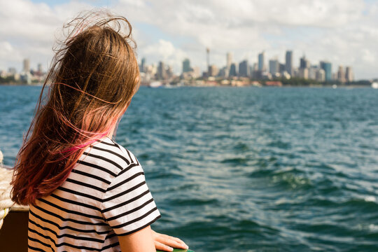 person on ferry looking at Sydney city