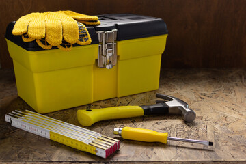 Construction tools and toolbox on wooden tablel background texture. Tool box