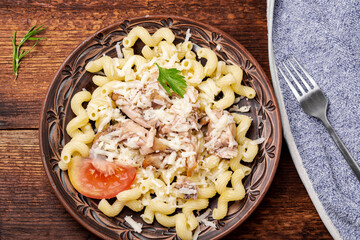 Peeled mussels with pasta on a dark wooden background.