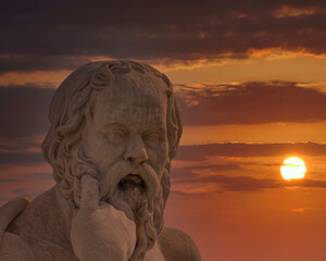 Socrates the ancient Greek philosopher statue and dramatic sundown, Athens Greece