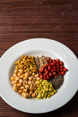Vegan food. Sprouted grains in white dish on bamboo background