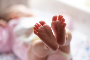 Feet of unrecognizable newborn baby