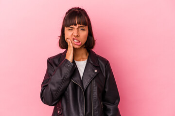 Young mixed race woman isolated on pink background having a strong teeth pain, molar ache.