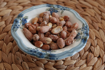 Close up of peanuts prepared in a rustic ceramic bowl	
