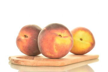 Naklejka na ściany i meble Three juicy organic peaches on a cutting wooden board, close-up, isolated on white.