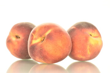 Several ripe organic peaches, close-up, isolated on white.