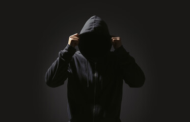 Fototapeta na wymiar Silhouette of anonymous man on black background