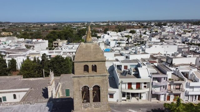 Aerial View of the Golden Madonna Statue over the Belltower of the Church SS. Maria Addolorata in Taviano, Apulia, Italy.